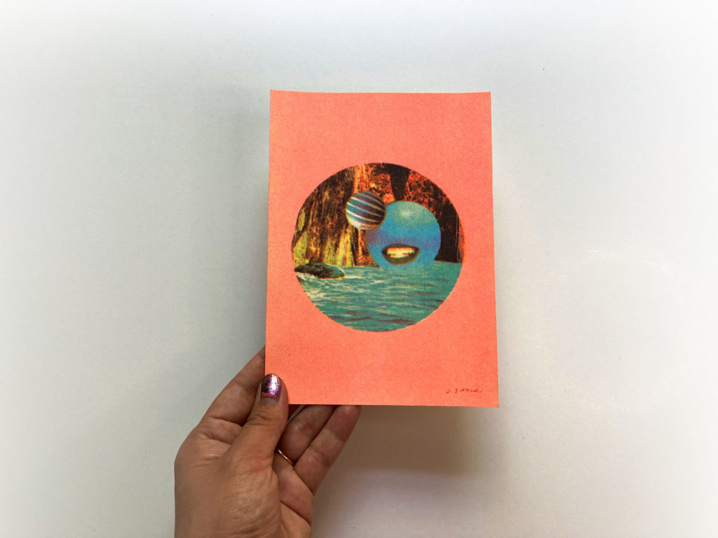 hand holding a risograph print blue smile product photo