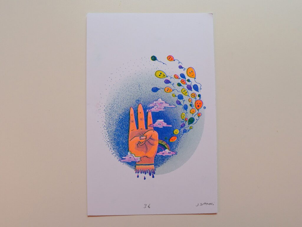 Healing Hands print of an open palm with a trail of colorful bubbles