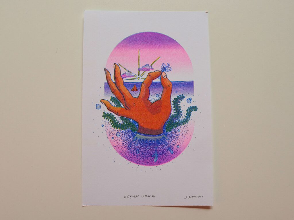 Healing Hands print of a hand rising from the ocean inside a pink and purple oval