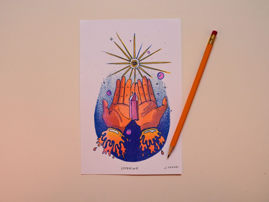Healing Hands print of two hands raised under a golden sunburst, with a pencil for scale