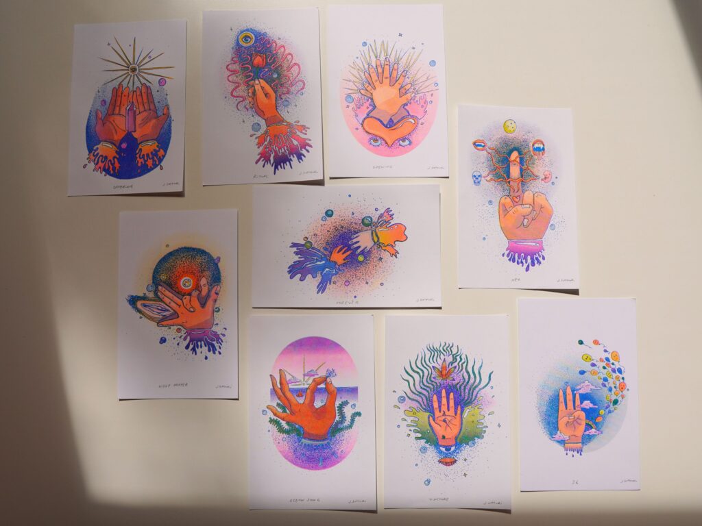 The nine Healing Hands risograph prints spread out on a table