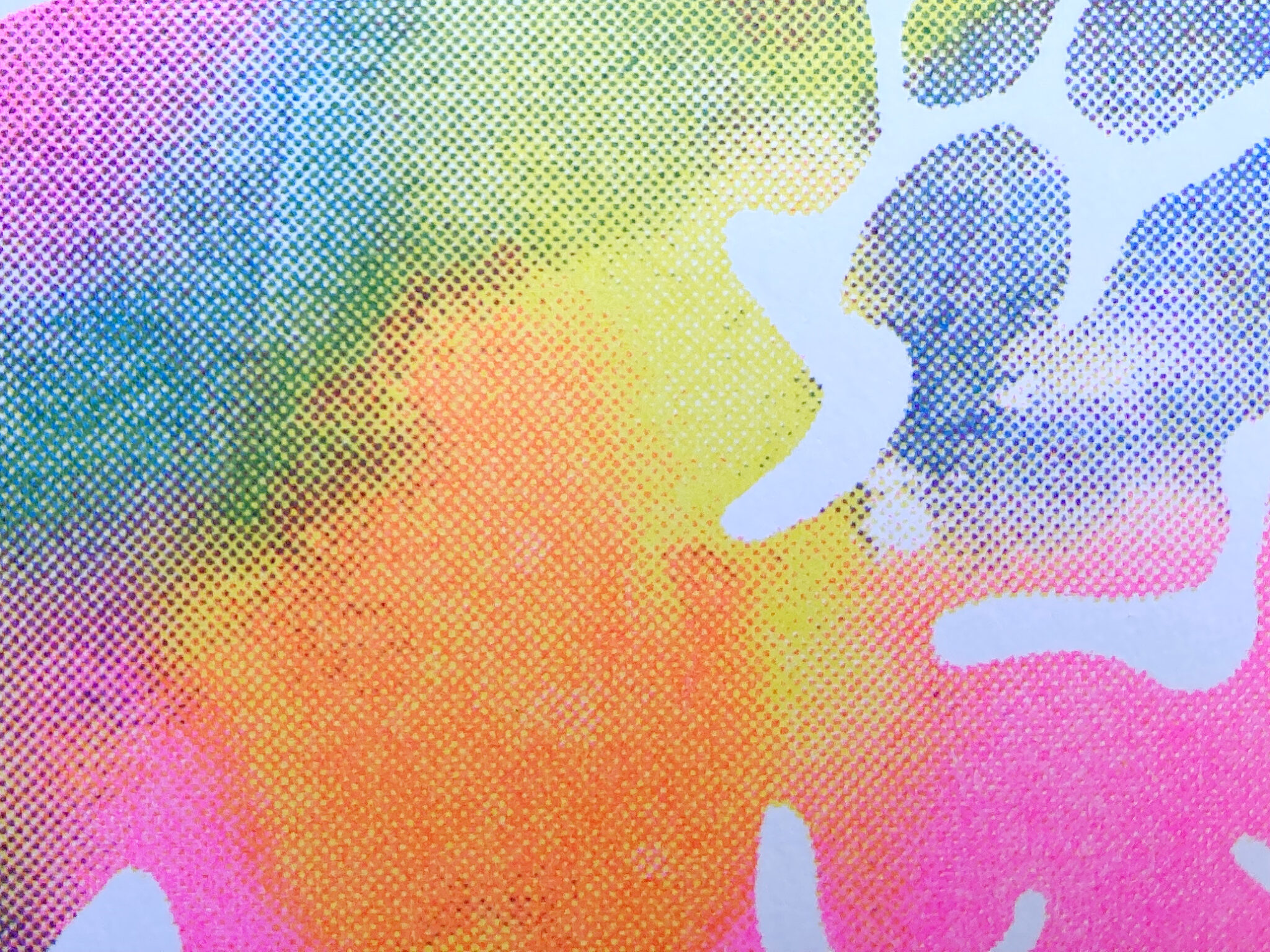 Close-up of riso ink texture in yellow, fluorescent pink and blue