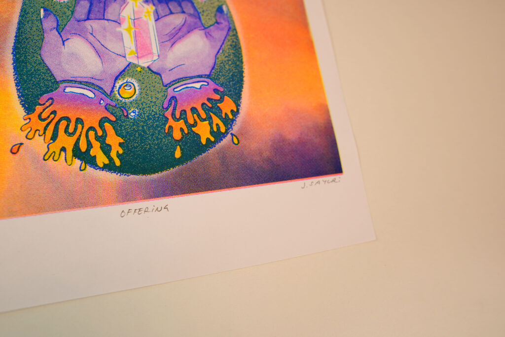 Angled view of the Offering risograph print showing the hands and crystal, with the handwritten title and signature on the white border